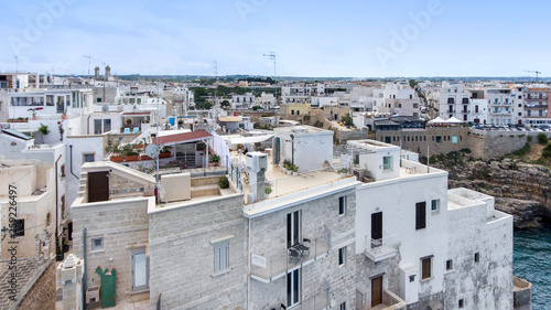 Beautiful view of old town in Polignano a Mare in Italy. Houses and buildings built on cliffs next to ocean or sea. Luxury lifestyle at the edge of the world. Concept of travelling and summer holidays © lainen