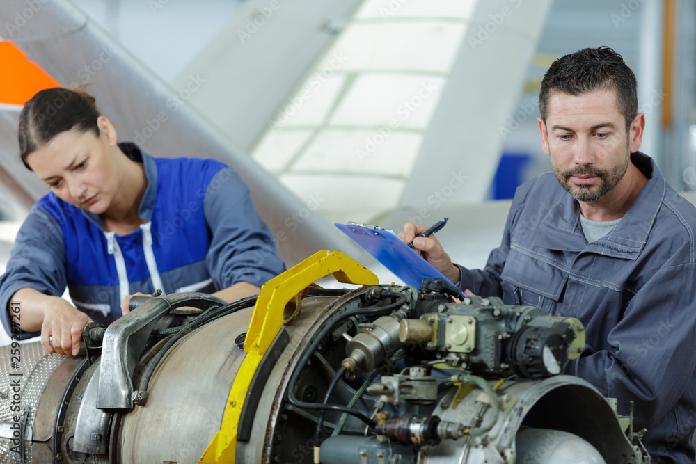 workers on airplane engine