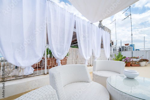 Rooftop terrace prepared for a baby shower. White and bright design to represent innocence and newlife. Beautiful patio with herbs and plants. Cactus in the background  
