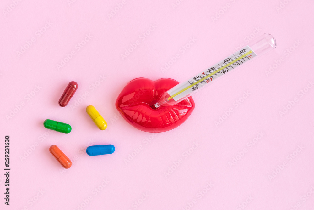 Thermometer in plastic lips and multicolored pills medicine abstract. Thermometer in plastic lips and multicolored pills medicine abstract.