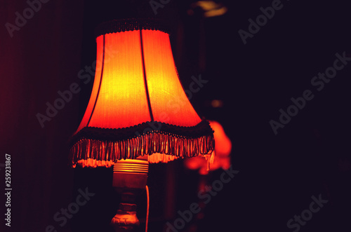 Decorative table lamp in bedroom. Cosy atmosphere at home