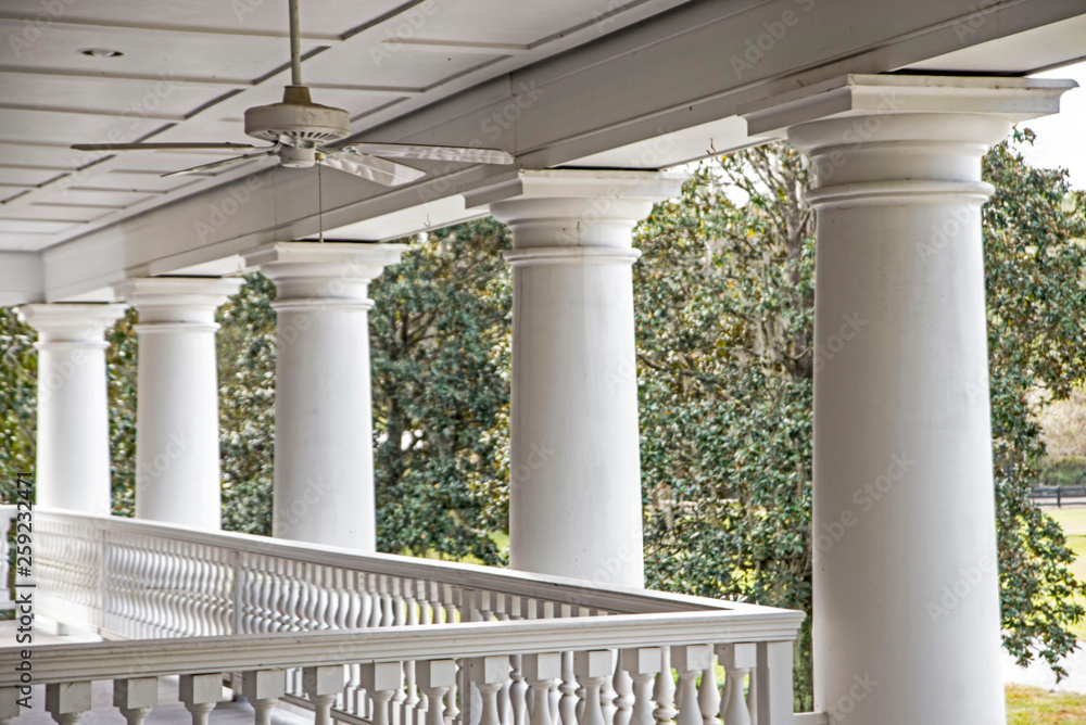 Large white stone pillars on a historic house in Charleston.