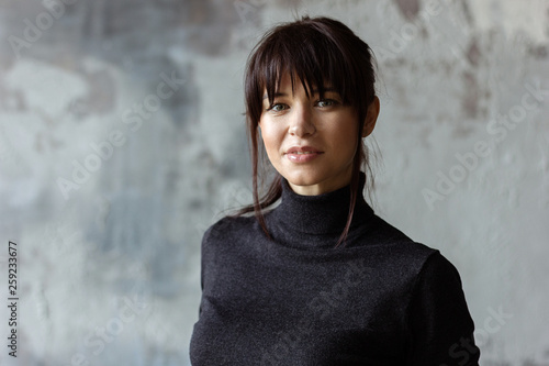 Beautiful young woman in black turtleneck