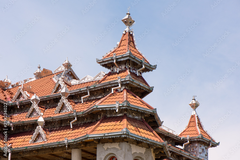 Traditional gypsy house with luxury decorations and ornaments on the roof in Huedin, Romania being under construction. Traditional gypsy house with luxury decorations and ornaments on the roof in Huedin, Romania being under construction.