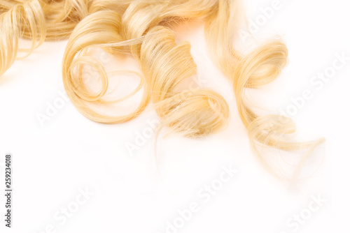 Human, natural light blond wavy hair on white isolated background. An example of a fashionable hairstyle for a poster, an advertisement or a hairdressing website. Extended, attached and beauty.
