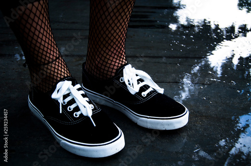 pair of black sneakers on dark background
