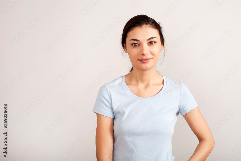 Portrait of young beautiful cute cheerful girl smiling looking at camera over white background Portrait of young beautiful cute cheerful girl smiling looking at camera over white background