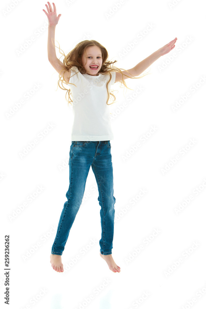 A little girl in a pure white t-shirt is jumping. The concept of A little girl in a pure white t-shirt is jumping. The concept of