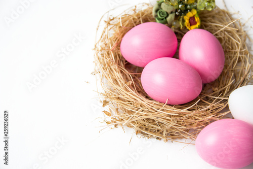 Easter colored pink eggs in egg nest, soft focus image. Happy Easter Card