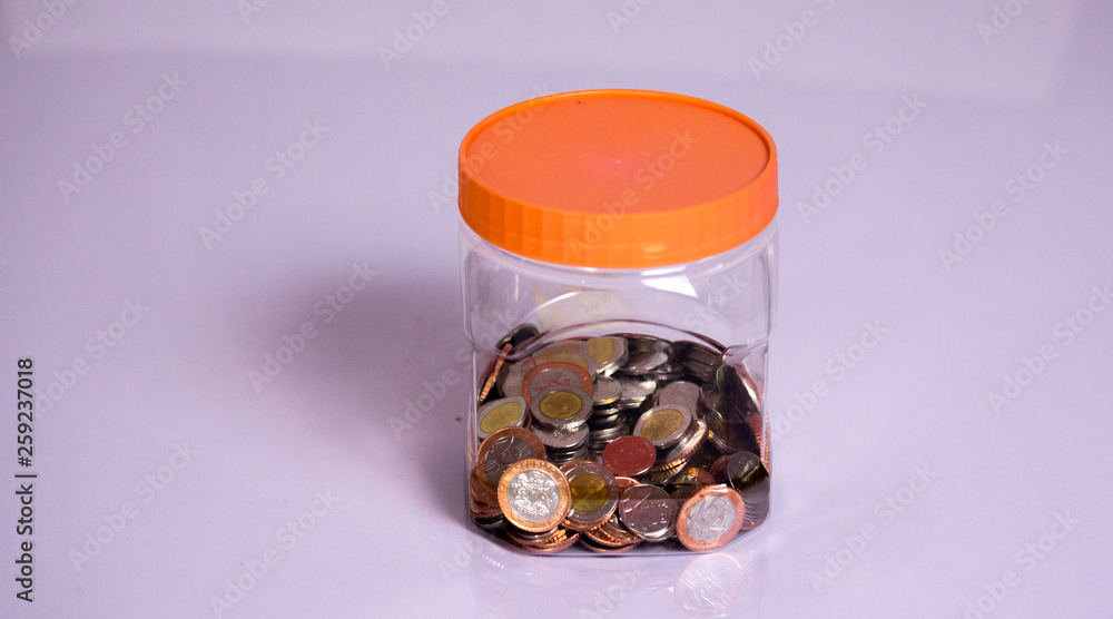coins and Savings in a transparent bottle coins and Savings in a transparent bottle
