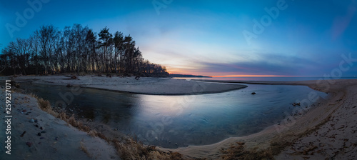 Panoramic view of the river flowing into the Baltic sea at sunset