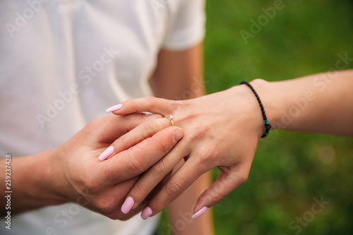 Man makes a marrige proposal to a girl. Gives her a ring for the engagement. Close-up hands