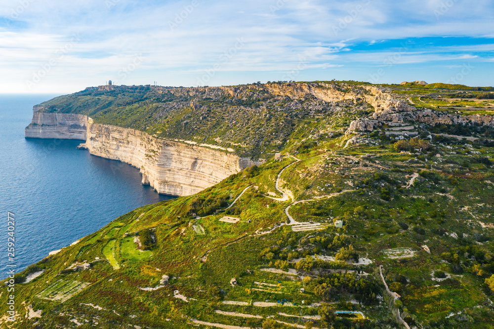Aerial view of Dingli cliffs and sea. Greeny nature and blue sea and sky. Malta island. 