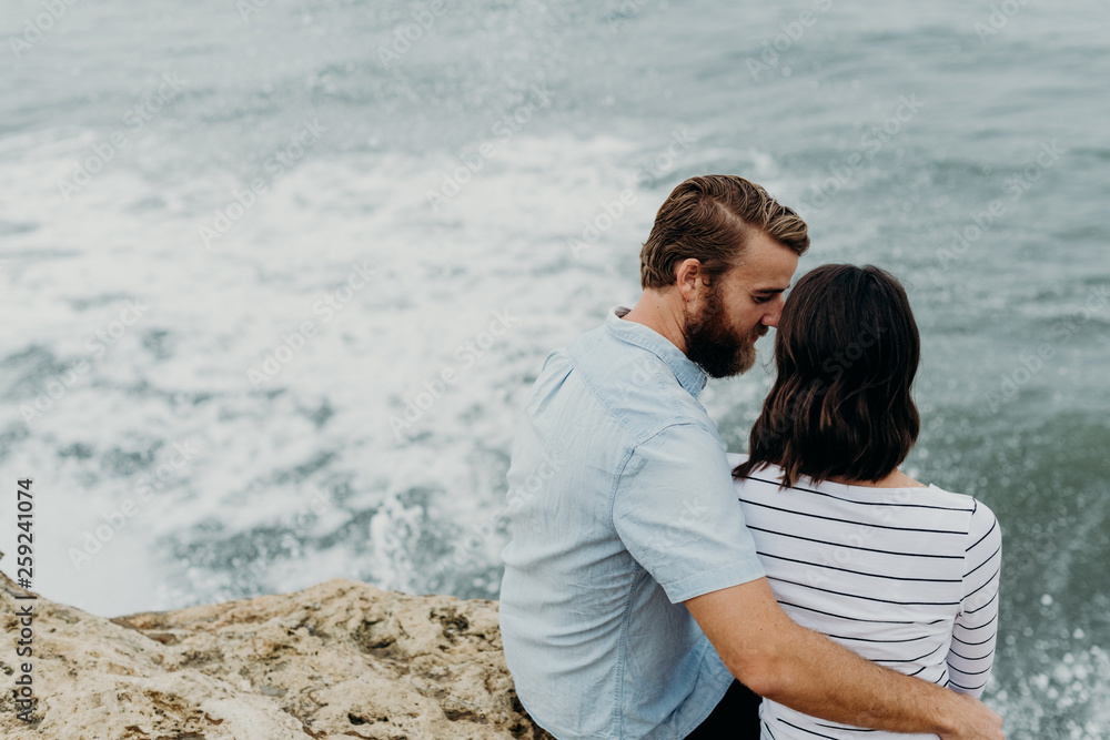 Couple embracing on an ocean cliff Couple embracing on an ocean cliff