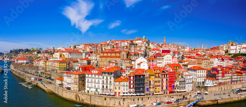 Fototapeta Naklejka Na Ścianę i Meble -  Porto Cityscape with Dom Luis I Bridge over Douro River and medieval Ribeira district at day time, Portugal
