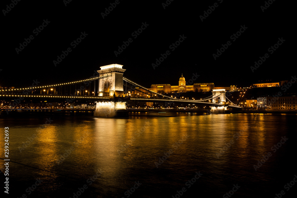 Night time view of the Buda Castle and the Szechenyi Chain Bridge over the Danube River in Budapest