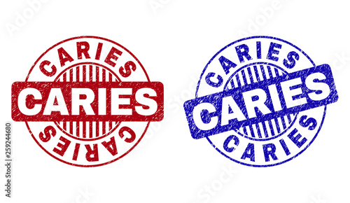 Grunge CARIES round stamp seals isolated on a white background. Round seals with grunge texture in red and blue colors. Vector rubber imprint of CARIES caption inside circle form with stripes.