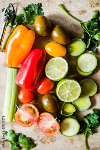 healthy food background  lime cut in half  celery  peppers  small colored tomatoes on a cutboard top view.