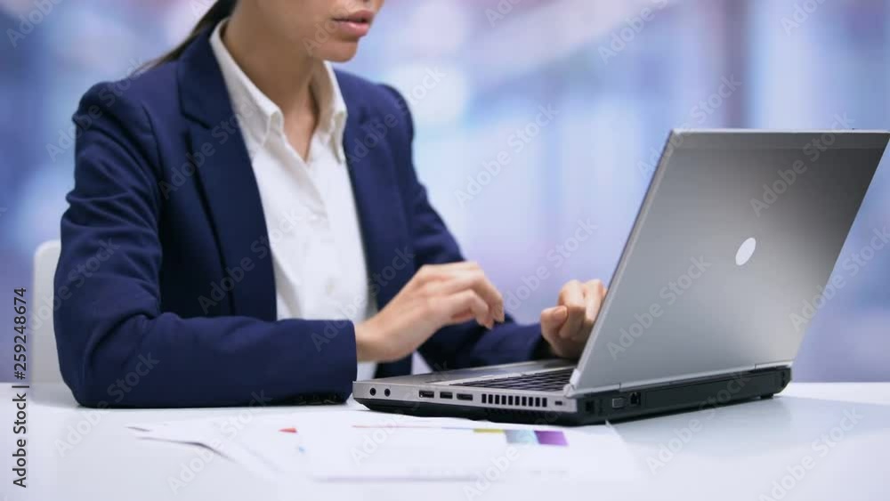 Female manager sending email by laptop, working in office, preparing report Female manager sending email by laptop, working in office, preparing report