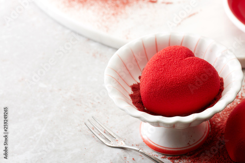 Red heart-shaped valentine cake on the dining table photo