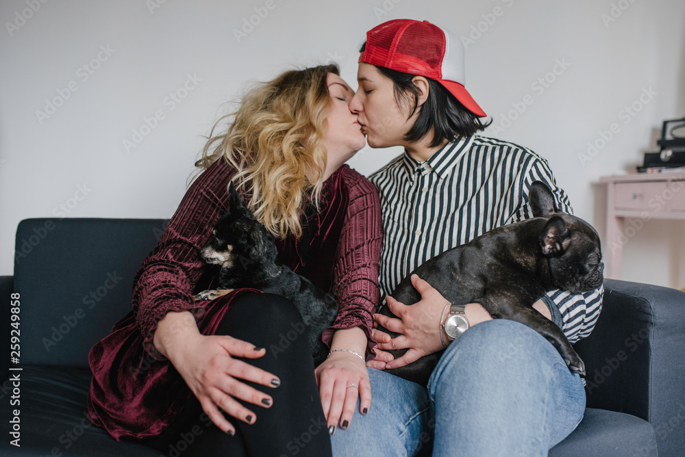 Lesbian couple with russian toy terrier and friench bulldog at home Lesbian couple with russian toy terrier and friench bulldog at home