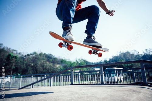 Skateboarder skateboarding at skatepark ramp photo