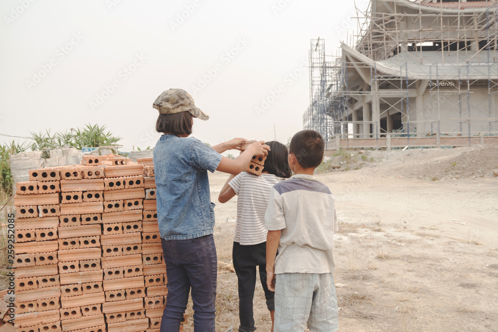Children working at construction site for world day against child labour concept.