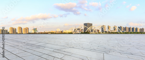 Empty square floor and city skyline panorama with bridge construction in shanghai at sunset