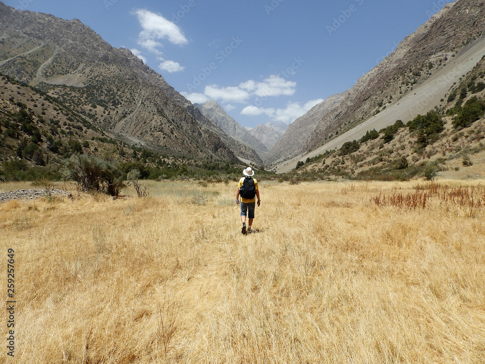 Man hiking. Wanderlust time. Man hiking in beautiful Fann mountains in Pamir, Tajikistan. Central Asia. Travel Lifestyle