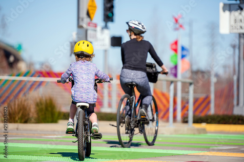 Mother and daughter go for bike ride on bike path