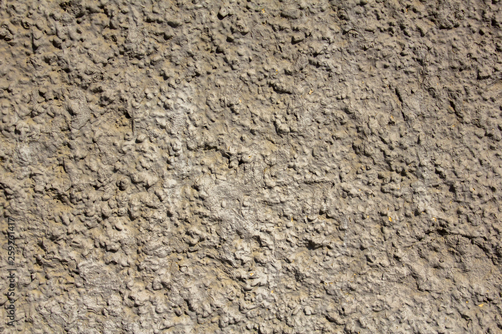 old white gray yellow shabby wall with deep uneven relief and shadows. rough surface texture