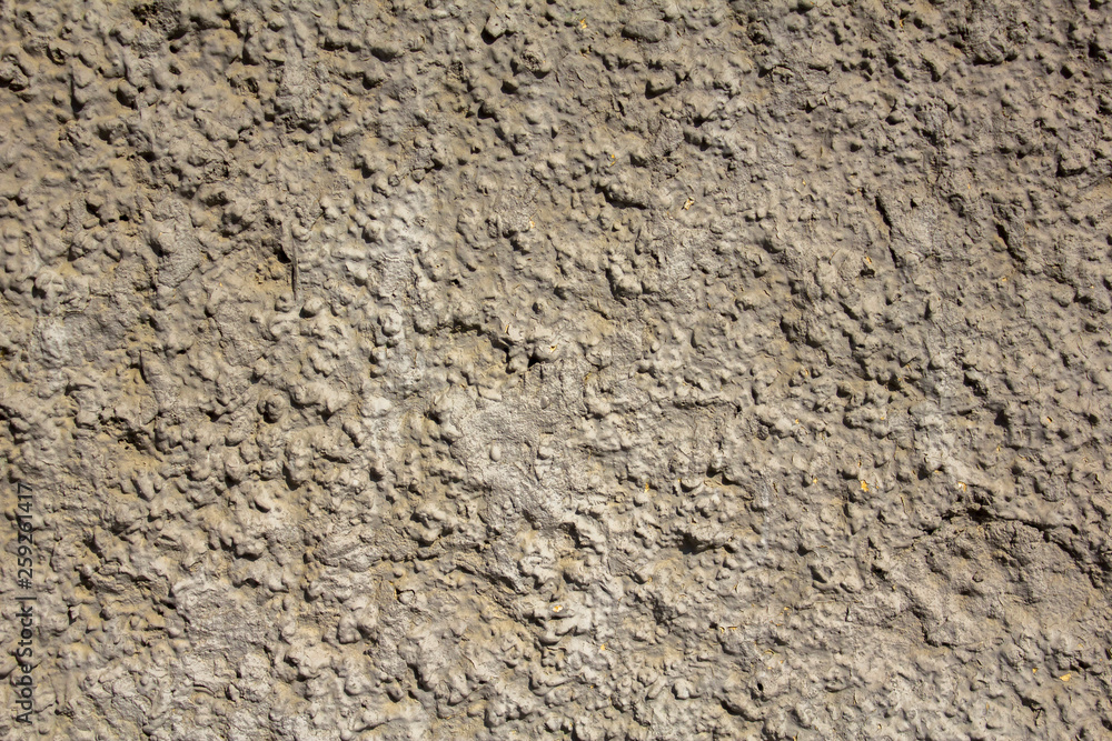 old white gray yellow shabby wall with deep uneven relief and shadows. rough surface texture old white gray yellow shabby wall with deep uneven relief and shadows. rough surface texture