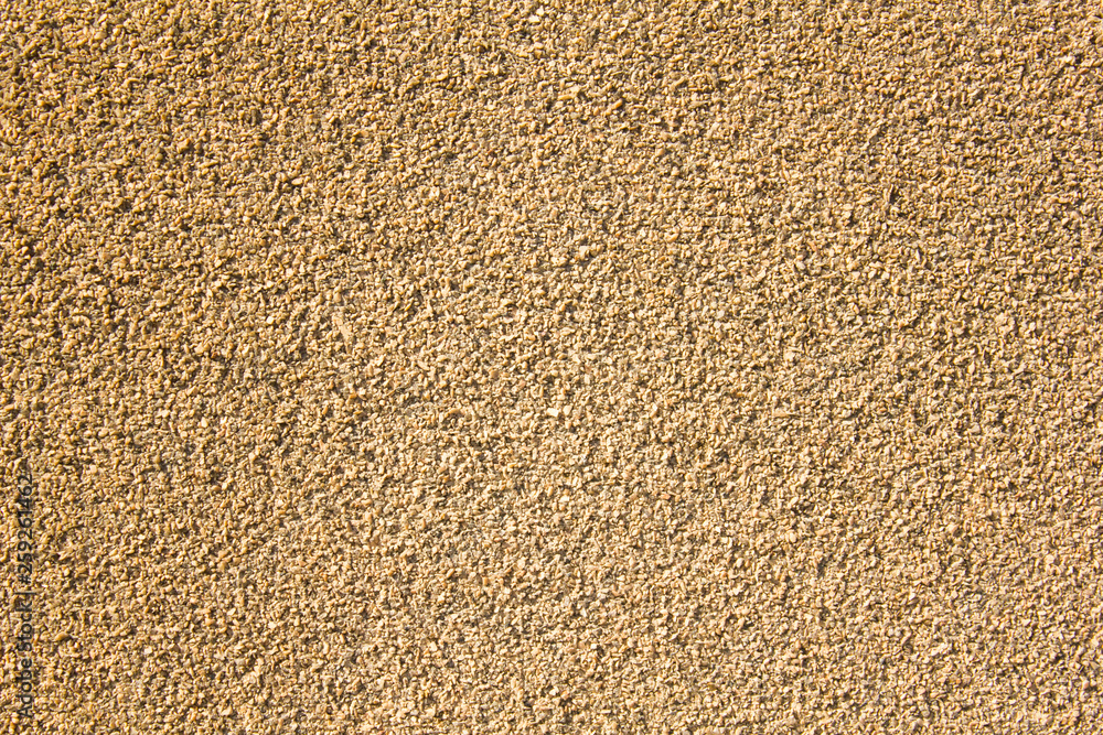 white yellow gray granular surface of small stones of different shapes and sizes. rough surface texture white yellow gray granular surface of small stones of different shapes and sizes. rough surface texture