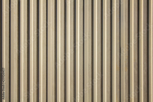 white gray yellow old dirty wall with vertical lines and shadows. rough surface texture