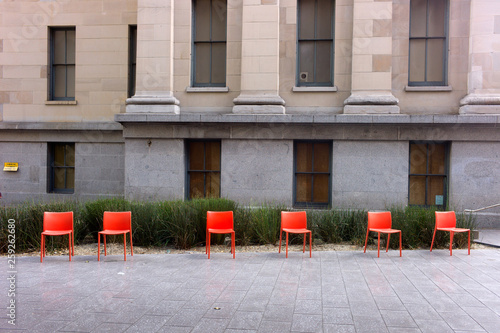 Photography Red Chairs with Old Mint building  in background in San Francisco Old Mint plaza