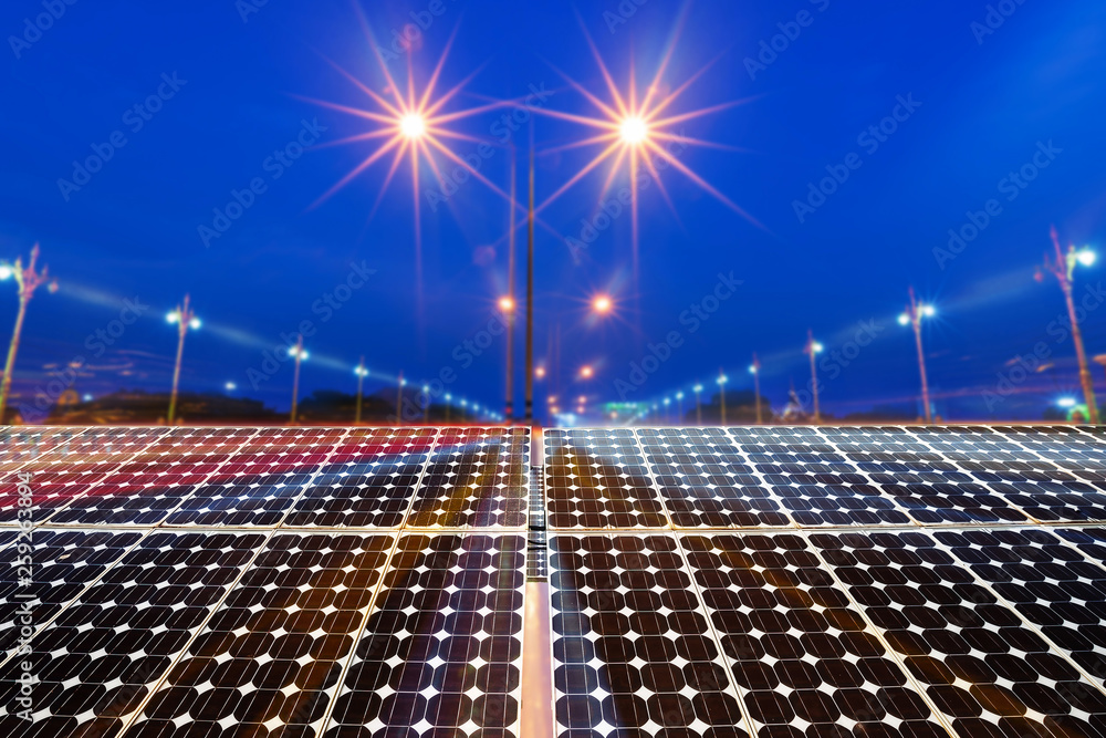 Texture of photovoltaic panels solar panel with city night light on the Road at night background, Alternative energy concept. - obrazy, fototapety, plakaty 