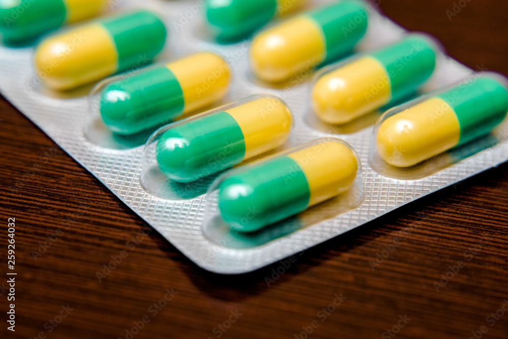 Packaging with pills is on a brown background Packaging with pills is on a brown background