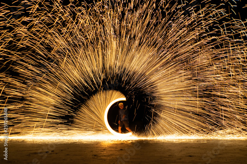 The bright spin fire sparks and fire show  in the night