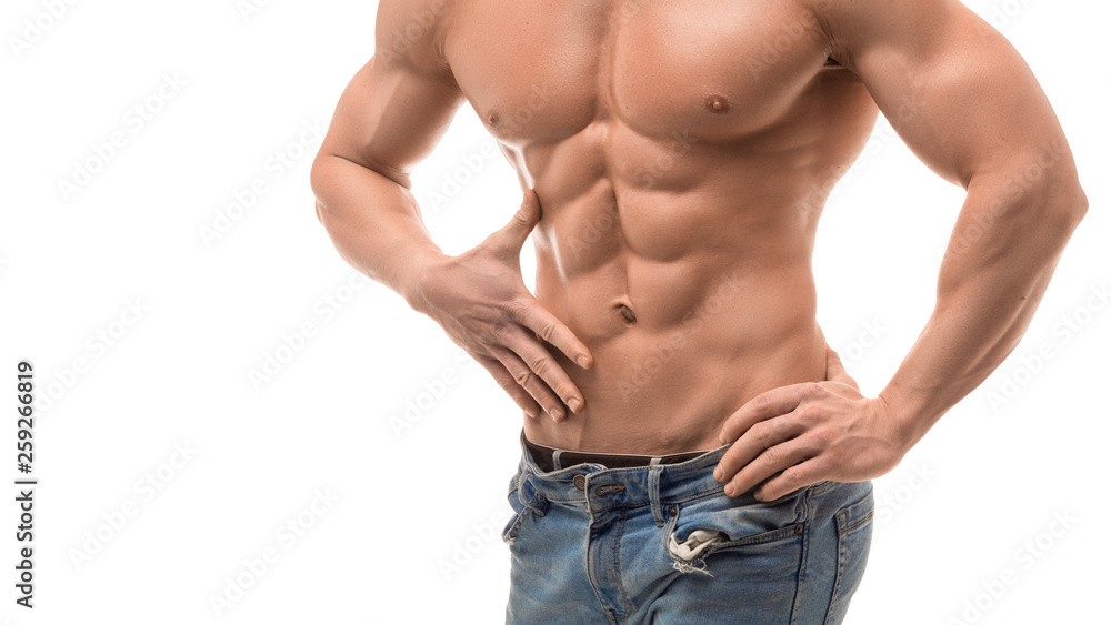 Male torso with perfect abs. Man in blue jeans touching his abs isolated on white.
