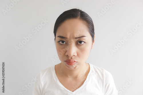 Canvastavla Sulk and grumpy face expression of woman in white t-shirt