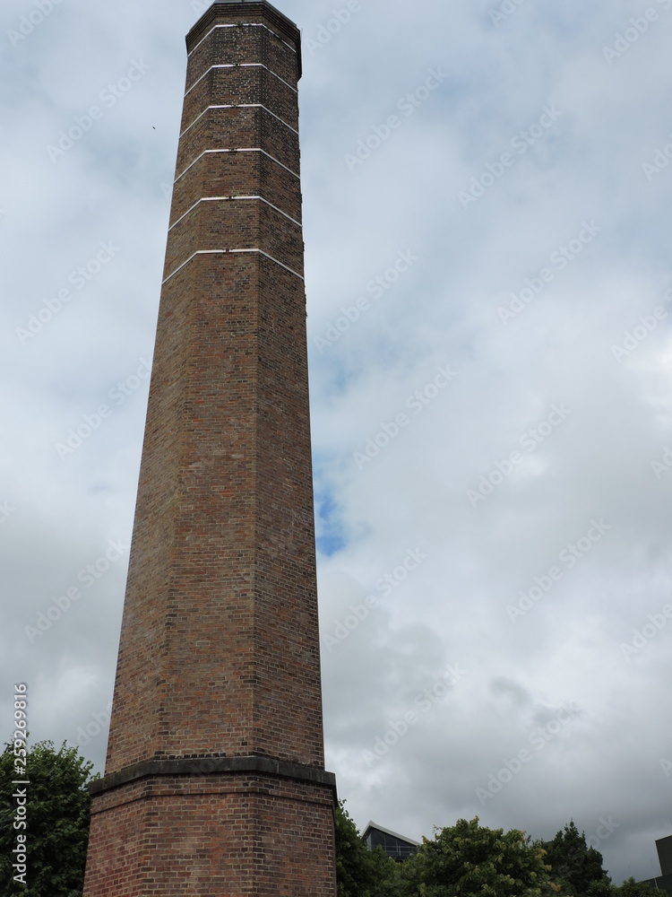 old factory chimney on background of blue sky