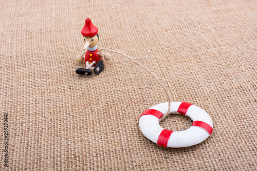 Wooden Pinocchio doll tied ...