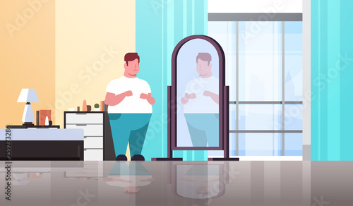 sad overweight man looking at himself reflection in mirror guy over size obesity concept modern apartment bedroom interior flat full length horizontal