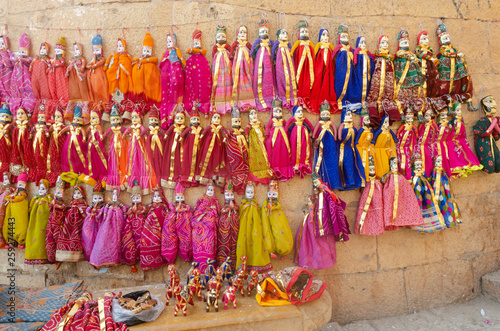 colorful puppets hanging on wall at Jaisalmer, Rajasthan, India © Paras