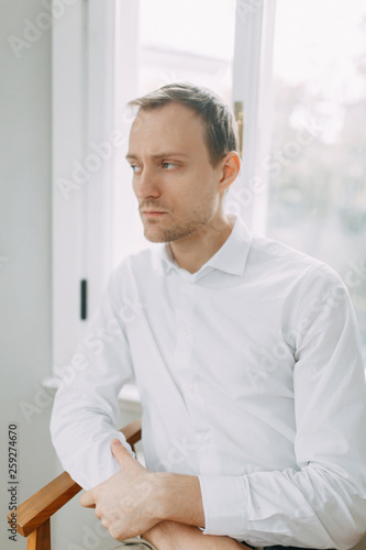 Portrait of a man in the European style. The preparations of the groom before the ceremony.