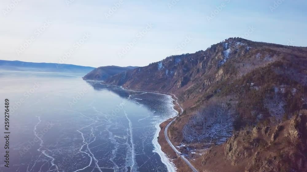Mountains from aerial view.. Cracks in ice from aerial view. Winter in Siberia, Baikal Lake. Mountains from aerial view.. Cracks in ice from aerial view. Winter in Siberia, Baikal Lake.
