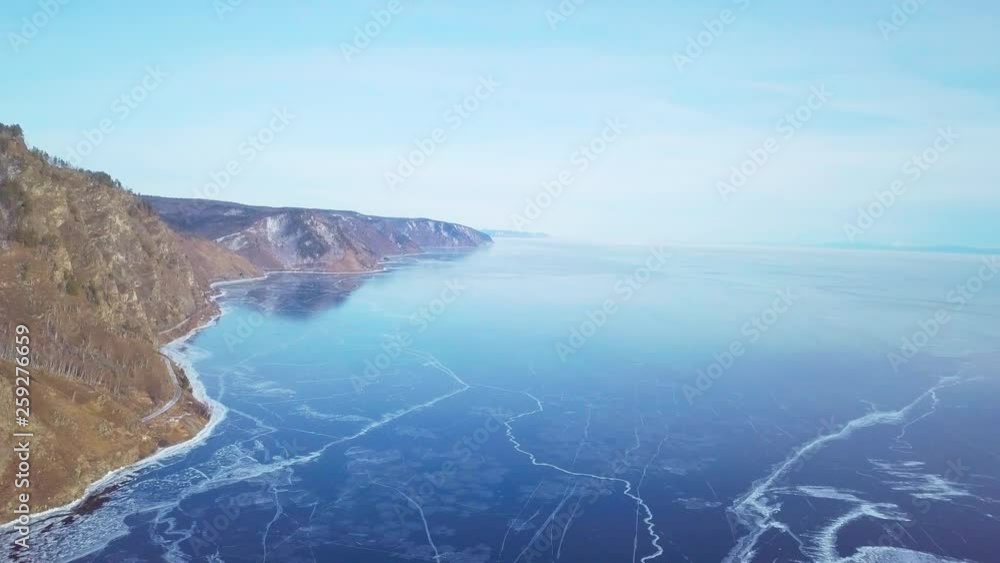 Mountains from aerial view.. Cracks in ice from aerial view. Winter in Siberia, Baikal Lake. Mountains from aerial view.. Cracks in ice from aerial view. Winter in Siberia, Baikal Lake.
