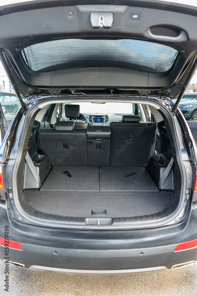 Clean, open empty trunk in the car SUV. Transformation of the seats for carrying luggage in the cabin.