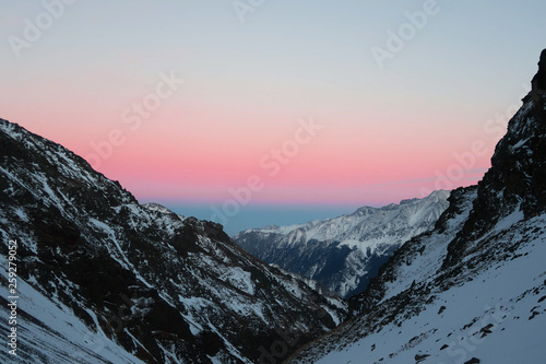 Sunset above the mountains ridge. Caucasian Mountains. Russia