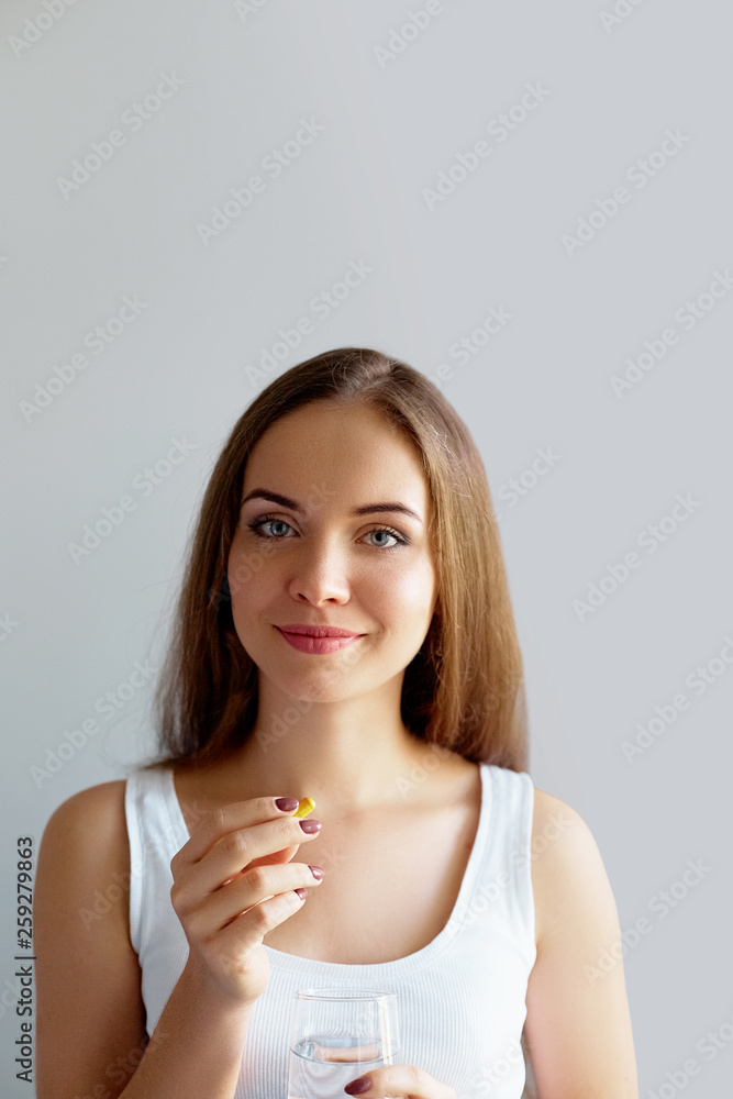 Beautiful Smiling Woman Taking Vitamin Pill. Dietary Supplement Beautiful Smiling Woman Taking Vitamin Pill. Dietary Supplement
